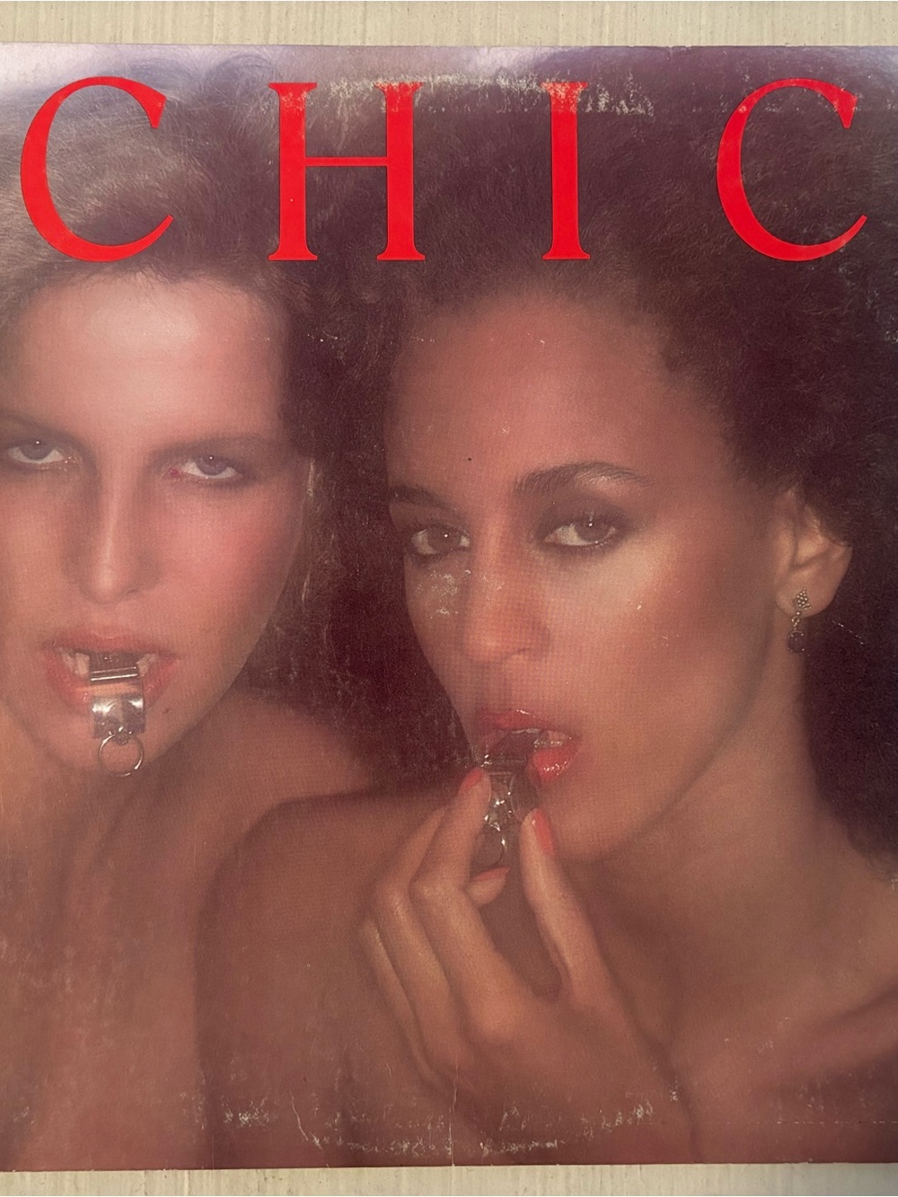 chic Album Art with Red Logo and Warm Skin Tones